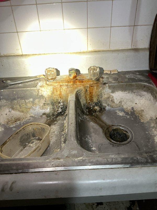 Responded to service call for kitchen sink valve shutoff. Upon arrival, accessed under-sink plumbing area and located water supply lines serving double-basin stainless steel sink fixture. Successfully shut off supply valves to isolate water flow to kitchen sink as requested, completing valve closure operation per customer requirements.