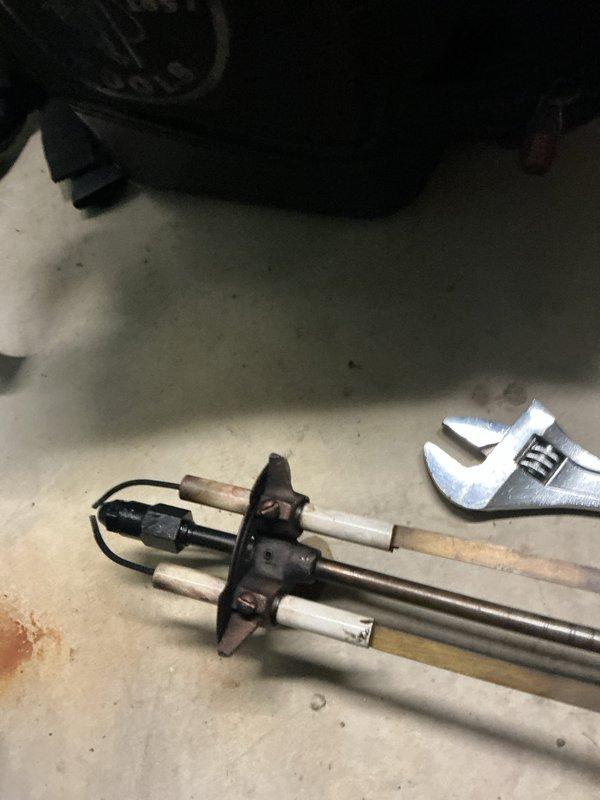 Responded to no-heat call on oil furnace with pilot light failure. Upon inspection, found flame sensor heavily corroded with significant mineral buildup and oxidation preventing proper flame detection. Removed and cleaned flame sensor assembly, restored proper operation, and verified pilot light ignition and main burner function.