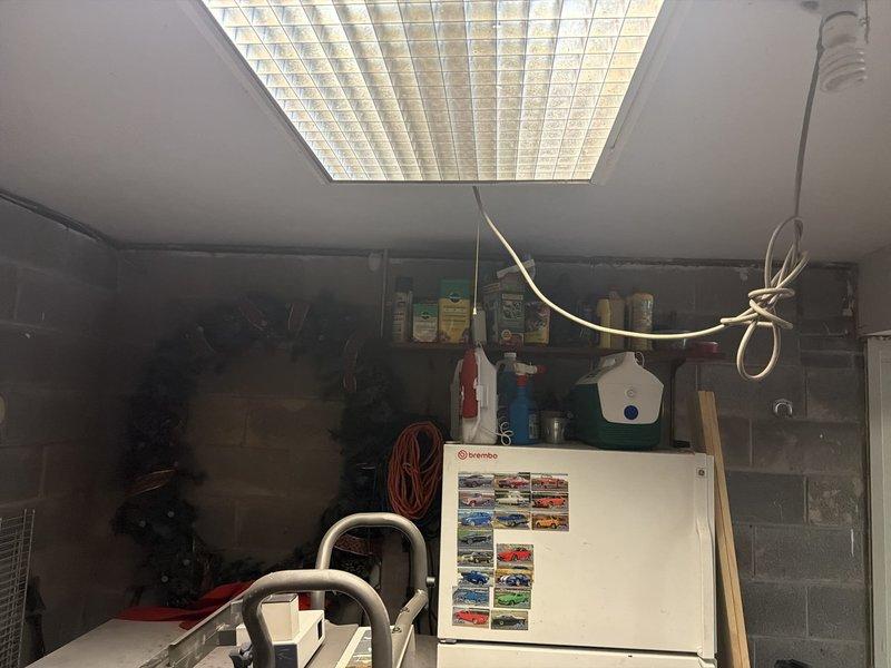 Installed a dedicated 20-amp AC circuit using 10/2 Romex wiring to provide power for a mini refrigerator in the basement utility area. Routed cable from the electrical panel through the ceiling joists, secured wiring per code requirements, and terminated connections at a new outlet receptacle to support the appliance load.