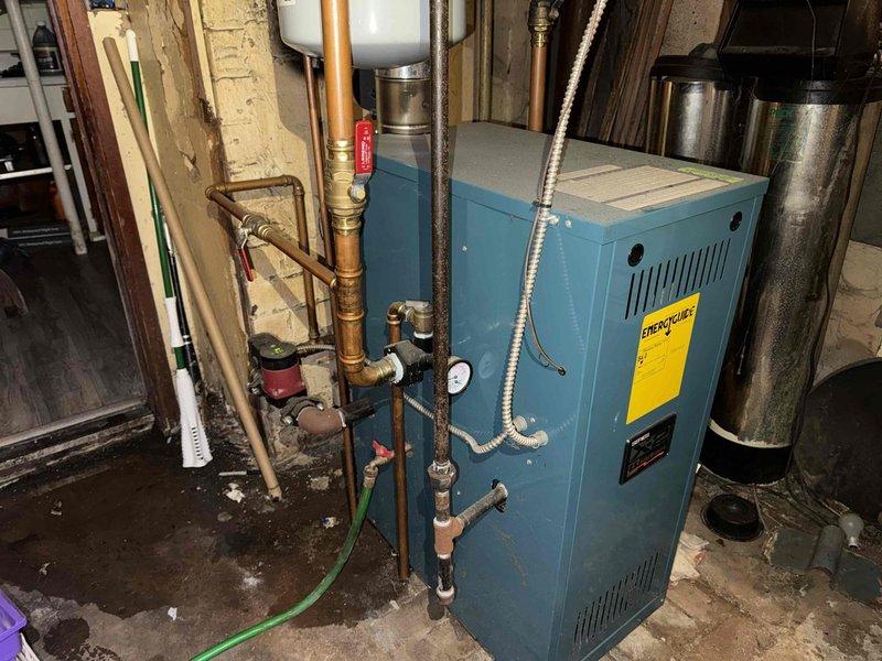 Completed routine maintenance inspection on residential boiler system for MVP customer. Performed visual assessment of teal-colored boiler unit, verified operational status of all connected components including copper piping, pressure gauge, circulator pump, and expansion tank. Documented equipment condition through photographic records showing boiler with proper ventilation, manufacturer labeling intact, and all plumbing connections secure. System found to be functioning within normal parameters with no immediate service requirements identified at time of visit.