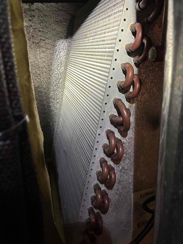 Completed comprehensive heating system maintenance inspection on HVAC unit. Thoroughly examined evaporator coil assembly, noting copper piping connections showing age-appropriate oxidation while aluminum fins remained in clean, serviceable condition. Inspected blower wheel assembly, documenting dust accumulation on blades and verifying proper mechanical operation of all components.