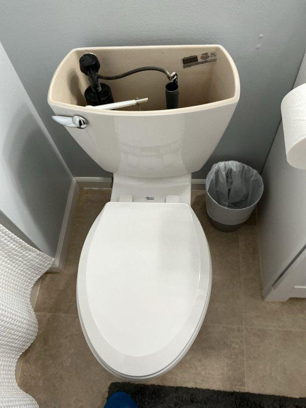 Responded to first-time service call for toilet replacement evaluation. Assessed existing white ceramic toilet with standard flush mechanism, noting internal tank components including fill valve and flush valve assembly in working condition. Provided on-site consultation and prepared replacement quote for basic American standard toilet installation. Scheduled weekend appointment per customer availability, with service call fee to be applied toward approved replacement work.