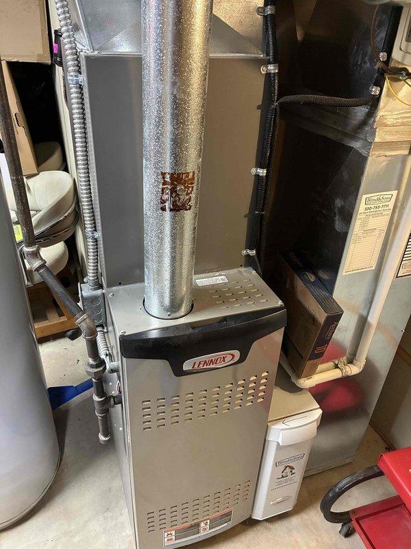 Performed routine maintenance on a 6-year-old Lennox air conditioning system. Inspected evaporator coil, refrigerant lines, and associated components; all found to be in operational condition with normal wear for age. System checked and confirmed operational.