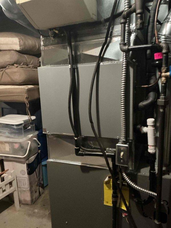 # HVAC Service - Water Leak

Responded to service call for water leaking from bottom of one of two Lennox furnaces in basement. Upon arrival, inspected both units and surrounding area. Observed water accumulation on concrete floor near affected furnace and evidence of moisture-related staining. 

Used level to check furnace installation and confirmed unit positioning. Identified condensate drainage issue as source of leak. Inspected condensate drain line, trap, and associated plumbing connections. Found blockage preventing proper drainage, causing water to overflow from condensate collection system.

Cleared obstruction from condensate drain line and verified proper flow. Tested condensate pump operation and confirmed functionality. Cleaned debris from drain pan and surrounding area. Checked secondary drain safety switch for proper operation. Verified all drainage components functioning correctly with no further leakage observed.

Documented conditions with photographs showing equipmen