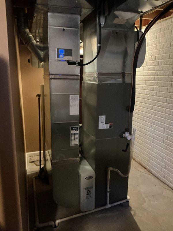 # HVAC Heating Maintenance Completed

Performed comprehensive MVP heating maintenance on residential forced air furnace system. Conducted thorough inspection of furnace unit, verified proper operation of all mechanical components, and checked refrigerant lines and ductwork connections for integrity. Examined condensate drainage system with white PVC piping to ensure proper flow and prevent backup issues. Inspected thermostat control functionality and verified accurate temperature regulation. Assessed all visible ductwork including flexible black ducts and metallic supply runs for secure connections and proper airflow. Confirmed water heater and associated plumbing systems in mechanical room were operating safely alongside HVAC equipment. System operating within normal parameters with no immediate concerns identified.