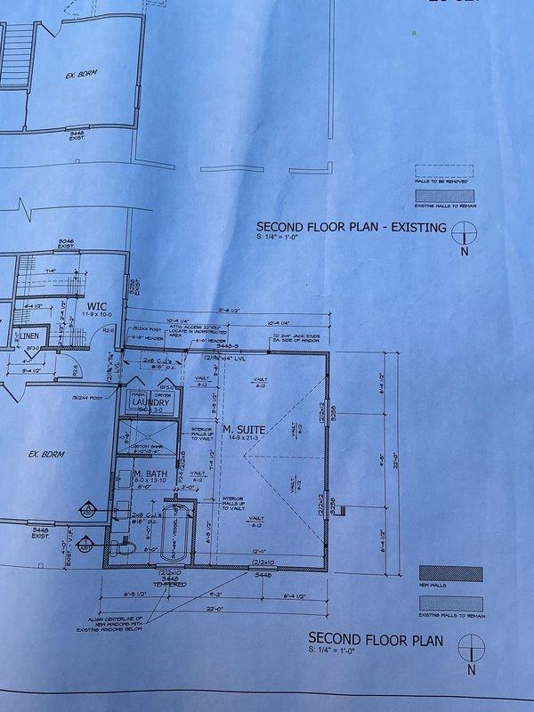 Conducted on-site plumbing assessment for residential addition project during active construction phase. Reviewed architectural blueprints indicating second floor expansion including master suite, master bathroom, walk-in closet, laundry room, and pantry. Evaluated existing plumbing infrastructure and framed wall structures to determine fixture placement requirements and supply/drain line routing for new bathroom and laundry facilities. Documented site conditions including concrete foundation, framed walls, and construction progress through photographic documentation to support detailed estimate preparation for required plumbing fixtures and rough-in installation.
