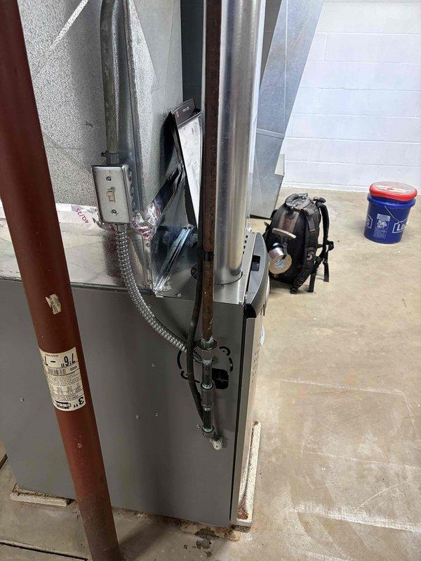 Completed installation of 80% AFUE furnace unit in garage utility area. Installed air handler with proper electrical connections, condensate drain line, flexible metal conduit, and gas supply piping. Verified all wiring terminations at control board and terminal strip, ensuring proper color-coded connections for thermostat control, power supply, and safety circuits. Unit mounted securely against insulated wall with all required clearances maintained for safe operation and future serviceability.