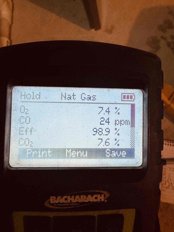 Completed MVP recurring heating maintenance visit. Inspected heat exchanger assembly, confirming proper condition and airflow through the evaporator coil mesh structure. Performed combustion analysis using digital analyzer, recording optimal efficiency at 98.9% with oxygen levels at 7.4%, carbon monoxide at 24 ppm, and carbon dioxide at 7.2%, all within acceptable parameters for natural gas operation. System operating safely and efficiently with no issues identified.