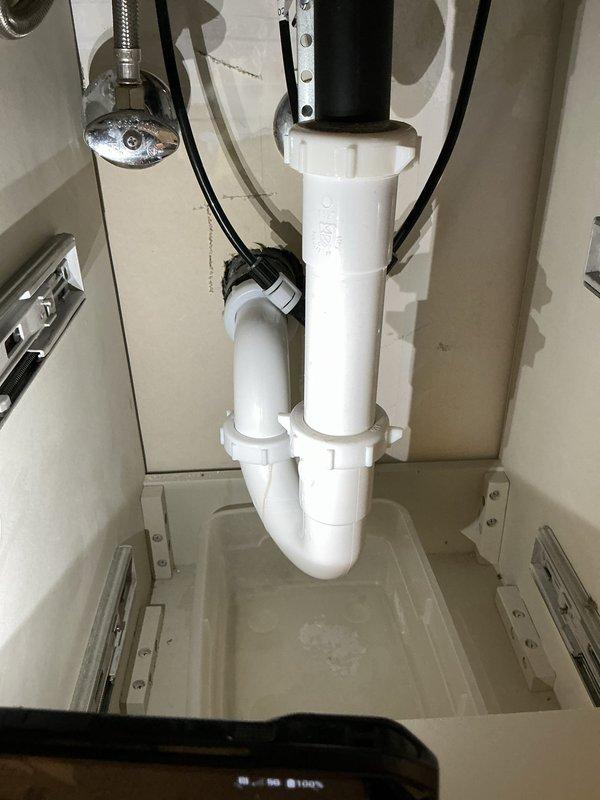 Responded to kitchen sink clog with accompanying odor. Upon arrival, inspected the P-trap assembly and drainage system beneath the kitchen sink. Removed and cleaned the heavily corroded drain components, addressing significant rust buildup and debris accumulation that was causing the blockage and foul smell. Cleared the drainage line, reassembled the P-trap system, and verified proper water flow and drainage function. System tested and restored to normal operation.