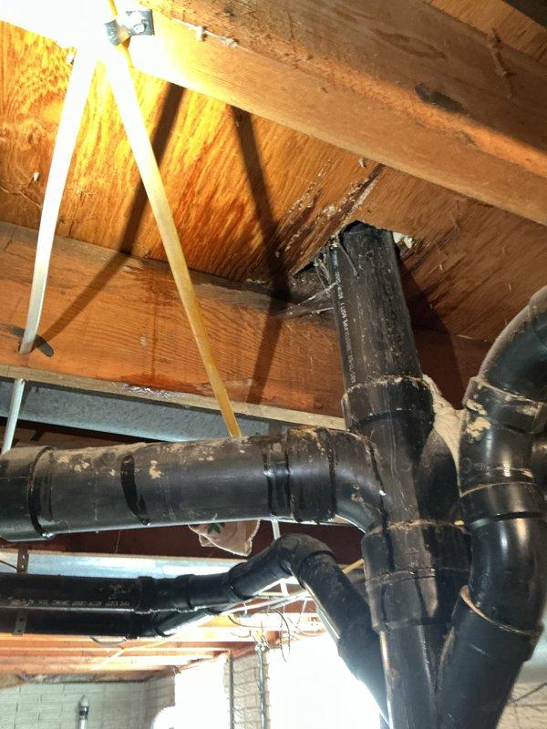 Responded to water leak originating from upstairs toilet with visible damage in basement area. Upon arrival, accessed crawl space to inspect plumbing infrastructure serving second-floor bathroom. Located source of leak at toilet supply line connection. Identified compromised pipe fitting allowing water to travel through floor joists into basement ceiling area. Secured water supply, replaced faulty connection with proper fitting, and tested system under pressure to verify repair integrity. No further leakage detected upon completion of pressure test.