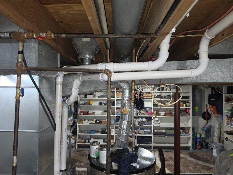 Removed and reinstalled two 2-inch flue pipes to ensure proper venting compliance and structural integrity throughout the system. Corrected outdoor terminations for both flues, ensuring proper clearances, weatherproofing, and code-compliant installation. Utilized 60 feet of 2-inch flue piping to complete the routing from heating equipment through the building structure to exterior termination points, ensuring clean penetrations through joists and proper support throughout the run.