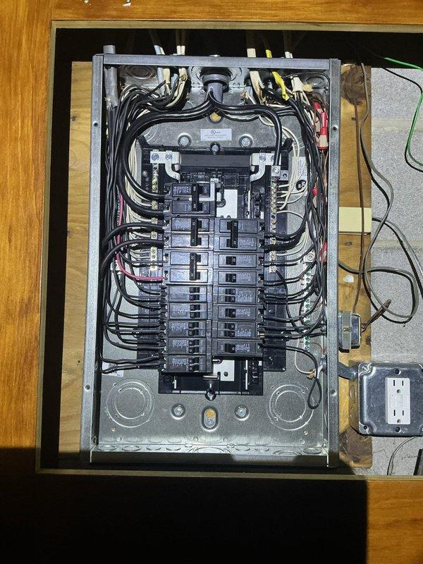 Completed 100-ampere electrical service upgrade including installation of new main distribution panel with updated circuit breaker configuration. Updated grounding system to meet 2023 National Electrical Code requirements and installed exterior disconnect switch as mandated by current code standards. Installed whole home surge protection device to safeguard electrical system and connected appliances from voltage spikes. All wiring connections properly terminated, labeled, and secured within panel enclosure with appropriate wire management.