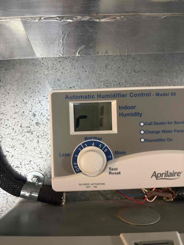 Completed secondary installation phase for 90% AFUE furnace system. Installed and configured Aprilaire Model 60 automatic humidifier control unit with digital display, integrated into the air handler ductwork with proper drainage connections via corrugated tubing. Control unit is operational and set to maintain optimal indoor humidity levels with all indicator functions verified working correctly.
