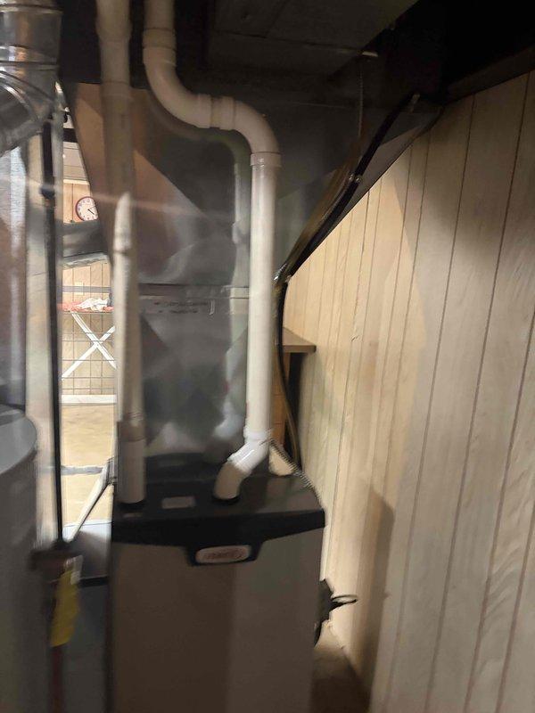 Completed secondary installation phase for 90% AFUE furnace system. Installed and configured Aprilaire Model 60 automatic humidifier control unit with digital display, integrated into the air handler ductwork with proper drainage connections via corrugated tubing. Control unit is operational and set to maintain optimal indoor humidity levels with all indicator functions verified working correctly.