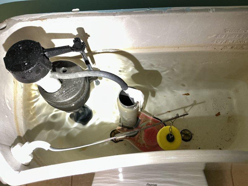 Responded to service call for leaking faucet and toilet. Upon inspection, examined kitchen faucet at base and surrounding countertop area, checking for signs of water intrusion or loose connections at the deck plate. Inspected toilet tank components and found visible water staining, mineral deposits, and sediment accumulation indicating long-term hard water exposure. Assessed flush valve assembly, fill valve mechanism, and flapper seal for proper operation and potential leak sources. Documented existing conditions of both fixtures for repair recommendations.