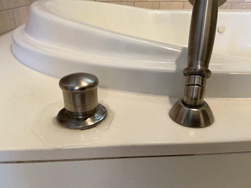 Responded to service call for leaking faucet and toilet. Upon inspection, examined kitchen faucet at base and surrounding countertop area, checking for signs of water intrusion or loose connections at the deck plate. Inspected toilet tank components and found visible water staining, mineral deposits, and sediment accumulation indicating long-term hard water exposure. Assessed flush valve assembly, fill valve mechanism, and flapper seal for proper operation and potential leak sources. Documented existing conditions of both fixtures for repair recommendations.