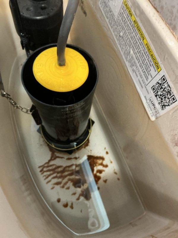 Responded to service call for toilet leaking at base. Upon inspection, identified failed wax ring and mounting hardware causing water seepage. Documented existing conditions with photos showing toilet tank components and fill valve assembly. Ordered replacement parts for return visit to complete repairs, including new wax ring and mounting bolts to properly reseal toilet base and eliminate leak.