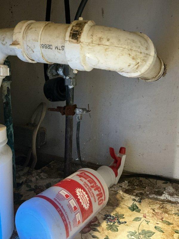 Responded to service call for leaking pipes in utility area. Upon inspection, identified deteriorated horizontal PVC pipe with visible staining and corrosion on metal fittings. Assessed vertical plumbing assembly and overhead pipe runs in basement area, noting aged infrastructure with rust accumulation on support column and compromised insulation wrapping on sections of piping. Documented conditions of all affected plumbing components and provided recommendations for necessary repairs to address active leaks and prevent future failures in the aging system.