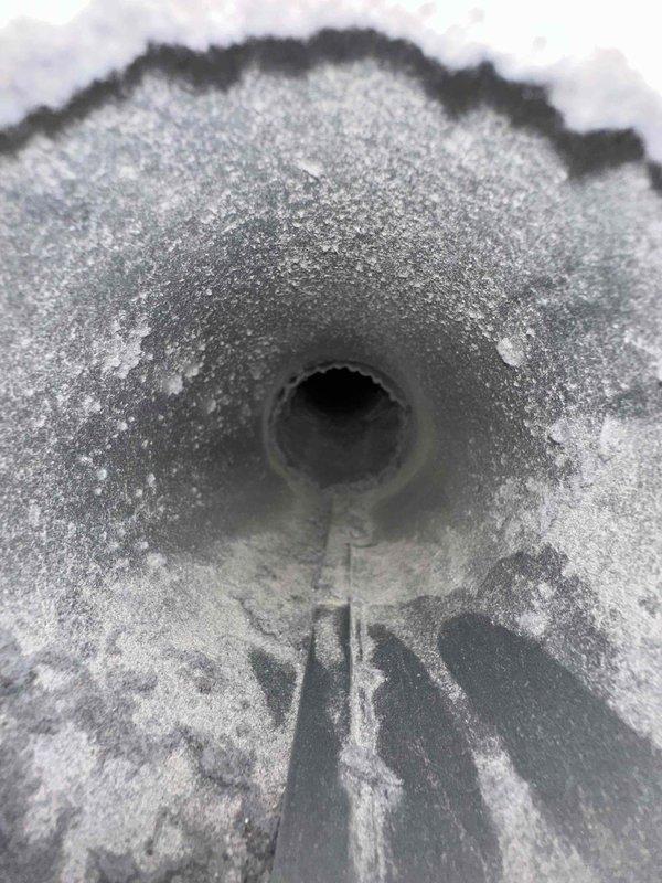 Completed dryer vent cleaning service at residential property. Upon arrival, inspected exterior vent termination point and discovered significant lint accumulation and frost buildup around the exhaust opening, indicating restricted airflow and potential moisture issues. The exterior vent cover showed signs of corrosion and weathering. Thoroughly cleaned the dryer vent system from interior connection point through exterior termination, removing accumulated lint and debris that was causing the blockage. Verified proper airflow and ventilation upon completion. Documented pre-service conditions showing the frost accumulation and deteriorated vent cover for customer records.