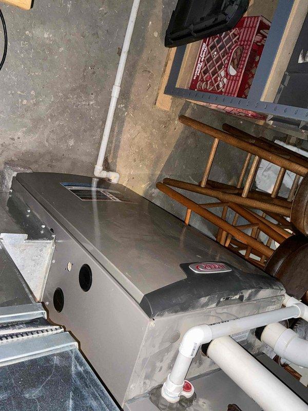 Performed estimate on 13-year-old furnace system presenting with leaking and noisy inducer motor. Upon inspection, identified significant corrosion on copper piping and deteriorating inducer motor assembly requiring replacement. Documented equipment condition with photographs showing advanced rust on horizontal piping, corroded connections, and overall system wear consistent with age. Provided quote for complete furnace replacement due to extent of deterioration and cost-effectiveness compared to component repair on aging equipment.