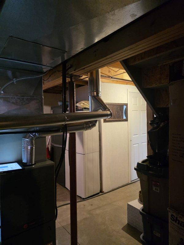 Completed MVP furnace maintenance in basement utility area. Performed comprehensive inspection of dark-colored furnace unit, including examination of heat exchanger, burner assembly, and all mechanical components. Verified proper operation of blower motor and checked all electrical connections for safety and functionality. Inspected metal ductwork system throughout the space, including horizontal supply ducts, flexible connectors, and rigid metal sections routed through ceiling joists. Confirmed all duct connections were secure and properly sealed. Tested furnace ignition sequence and verified proper flame characteristics. System operating within manufacturer specifications upon completion of maintenance service.