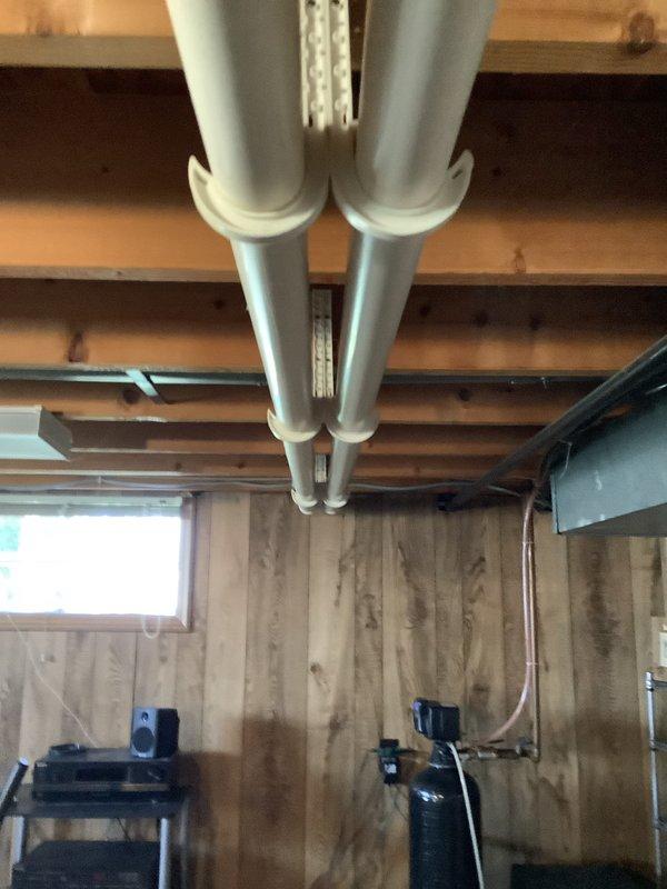 Completed comprehensive HVAC system assessment for furnace and air conditioning replacement in residential basement installation. Evaluated existing gray metal furnace unit with copper refrigerant lines, water heater configuration, and associated ductwork including parallel gray PVC ducts with white coupling joints supported by metal strapping. Provided detailed estimate for complete furnace and AC system replacement with equipment specifications and installation requirements for the 3-ton capacity system.