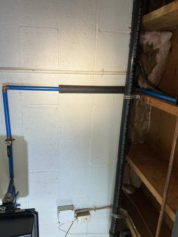 Responded to complaint of gurgling noises and odors emanating from garage sink drain when kitchen sink was in use. Conducted inspection of drainage system and plumbing connections in garage area. Upon examination, identified improper venting or potential partial blockage in shared drain line causing air pressure issues between fixtures. Documented existing plumbing configuration including exposed drain lines and mechanical systems for service records. Explained to customer that gurgling sounds indicate negative air pressure in the drain system, typically caused by inadequate venting or restriction in the common waste line. Recommended follow-up evaluation of vent stack and potential drain line cleaning to resolve cross-fixture drainage issues and eliminate odor problems.