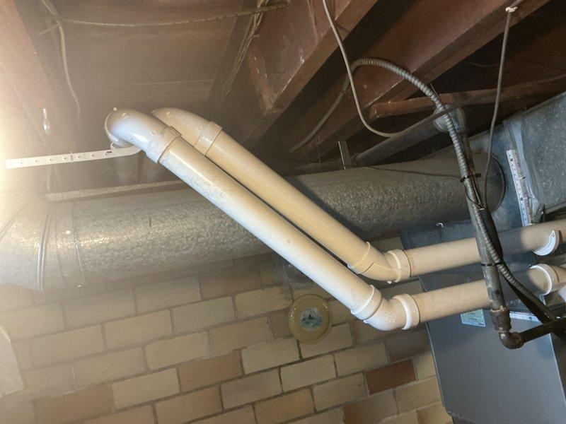 Completed installation of high-efficiency furnace system with proper venting and gas line connections. Installed and secured PVC vent piping with appropriate hangers and supports, routed condensate drain lines, and connected insulated gas supply line with brass fittings and shutoff valve. Verified all ductwork connections, tested system operation, and collected final payment to close out project.