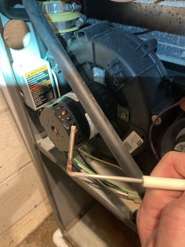 Responded to no heat call on 12-year-old furnace with history of operational issues following previous air conditioning installation. Upon inspection, discovered failed electrical connector with exposed wiring at blower motor assembly, along with significant corrosion and debris accumulation on mounting brackets and copper refrigerant lines. Replaced damaged wire connector, cleaned corroded components, and verified proper blower motor operation. Tested system through complete heating cycle and confirmed furnace now operating within normal parameters.