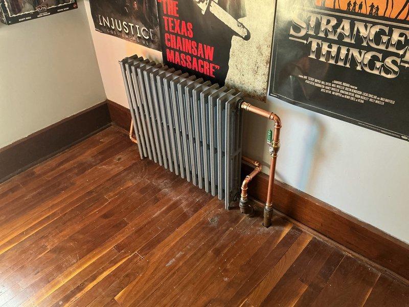 Replaced three old leaking radiators in upstairs bedrooms with new MR425X16 radiators measuring 4 7/16" deep, 25" high, and 16 sections (28" wide). Retrofitted existing 1" and 1 1/4" black iron piping to accommodate new units by installing 3/4" copper piping throughout. Installed new radiator valves and conical air vents on all three units to ensure proper operation and heat distribution. Fired heating system and bled air from all radiators to verify proper circulation and heat output. All three radiators now operational with no leaks detected.