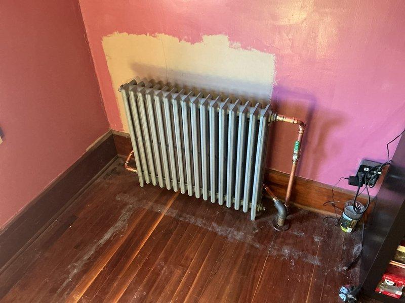 Replaced three old leaking radiators in upstairs bedrooms with new MR425X16 radiators measuring 4 7/16" deep, 25" high, and 16 sections (28" wide). Retrofitted existing 1" and 1 1/4" black iron piping to accommodate new units by installing 3/4" copper piping throughout. Installed new radiator valves and conical air vents on all three units to ensure proper operation and heat distribution. Fired heating system and bled air from all radiators to verify proper circulation and heat output. All three radiators now operational with no leaks detected.