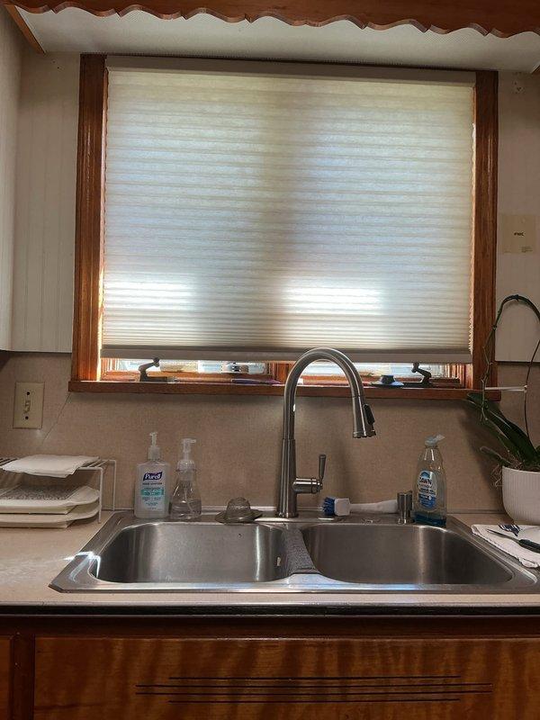 Converted fluorescent light fixture to LED technology by bypassing the existing ballast and installing ballast bypass bulbs. Work was completed on a ceiling-mounted fan light fixture with multiple frosted glass globes, successfully updating the lighting system to more efficient LED operation while maintaining the existing fixture housing and appearance.