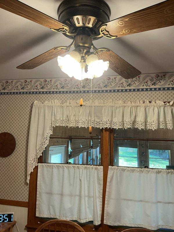 Converted fluorescent light fixture to LED technology by bypassing the existing ballast and installing ballast bypass bulbs. Work was completed on a ceiling-mounted fan light fixture with multiple frosted glass globes, successfully updating the lighting system to more efficient LED operation while maintaining the existing fixture housing and appearance.
