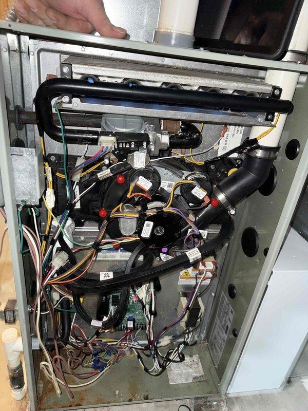 Responded to E32 venting error code on 8-year-old Trane gas furnace. Upon inspection, identified pressure switch issue causing false venting fault. Removed access panel, tested pressure switch and inducer motor operation, cleared debris from pressure tubing, verified proper draft operation, and confirmed system returned to normal heating cycle with error code cleared.