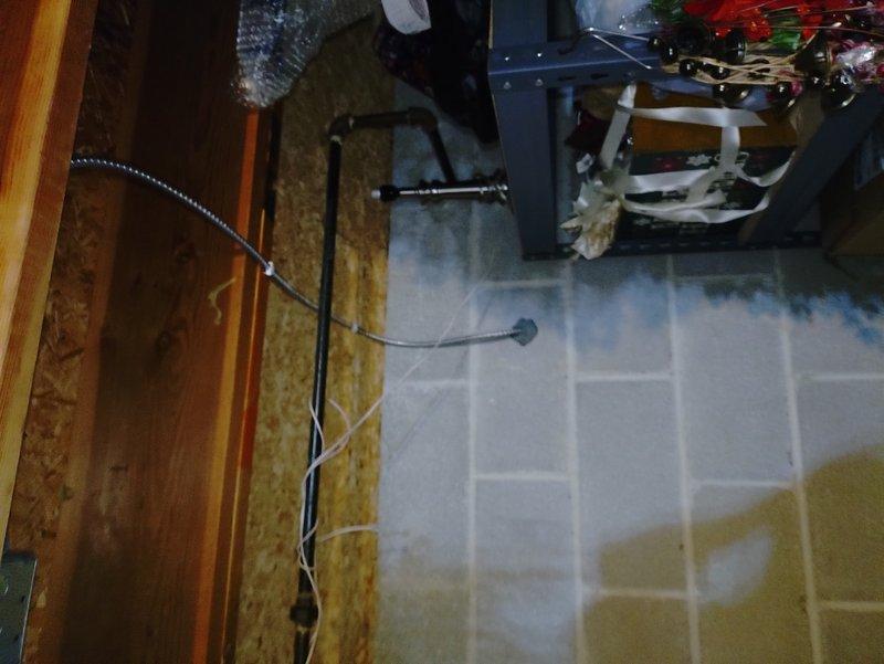 Installed a dedicated 20-amp circuit to power a new 1500-watt electric fireplace unit. Ran romex wiring across the basement through floor joists to the fireplace location, installed a junction box below the fireplace to convert to MC cable, and drilled a penetration to the left of the existing gas line. Fished MC cable up through the existing coal chute, drilled through the brick backing inside the fireplace, and installed a surface-mount receptacle in the rear of the fireplace cavity to provide power for the new electric unit.