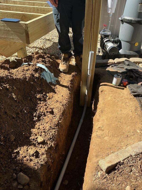 Installed GFCI-protected electrical circuit for pool pump by hand-digging trench approximately 7-10 feet alongside foundation and deck structure. Installed copper bonding ring around pool perimeter with inline skimmer bond connection and proper pump bonding per NEC requirements. Set electrical post for pump disconnect, ran conduit and wiring through excavated trench, and completed all grounding and bonding connections to ensure safe pool electrical system operation.