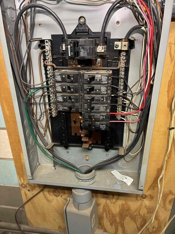 Installed dedicated electrical circuits for AC and furnace systems. Ran new wiring through attic space and mounted junction box on structural beam to facilitate proper wire routing and connections. Installed gray PVC conduit from junction box to electrical panel for code-compliant wire protection. Made all necessary wire terminations using appropriate wire nuts for red, black, green, and yellow conductors within junction box. Extended circuit wiring to main electrical panel and installed new circuit breakers in available positions on bus bars. Connected all hot, neutral, and ground conductors to their respective terminals and grounding bar within panel. Secured all wiring with proper mounting brackets and ensured conduit was firmly attached to structural members. Verified all connections were tight and properly torqued. Tested circuits for proper voltage and confirmed both AC and furnace systems received adequate dedicated power supply per manufacturer specifications and local electric