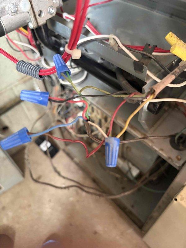 Completed second-phase air conditioning installation including coil installation and electrical connections. Installed new contactor with 30-amp rating and connected all low-voltage and line-voltage wiring to system components. Wired thermostat connections, capacitor, and control circuits using proper wire nuts and terminations, ensuring all electrical connections meet code requirements for safe operation of the new AC system.