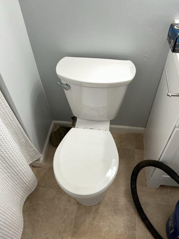 Installed a new American Standard Cadet Pro model toilet with round bowl and standard height in residential bathroom. Removed existing toilet fixture, prepared flange and mounting surface, set new two-piece toilet unit with proper wax ring seal, secured to floor, connected water supply line, and tested for proper operation and leaks. Installation completed successfully with all components functioning as specified.