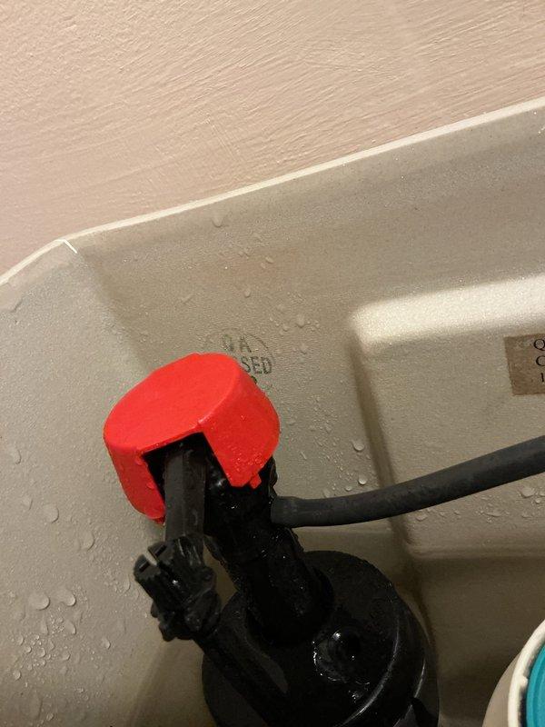 Responded to service call for toilet fill valve spraying water inside tank. Upon inspection, identified defective fill valve assembly causing water to spray internally rather than fill properly through designated outlet. Assessed that the issue likely stems from failed internal washer or rubber seal within the valve mechanism, though complete disassembly was not performed during initial diagnostic visit. Documented plumbing system configuration and water heater connections in utility area for reference. Recommended fill valve replacement to resolve the continuous spray condition and restore proper tank filling operation.