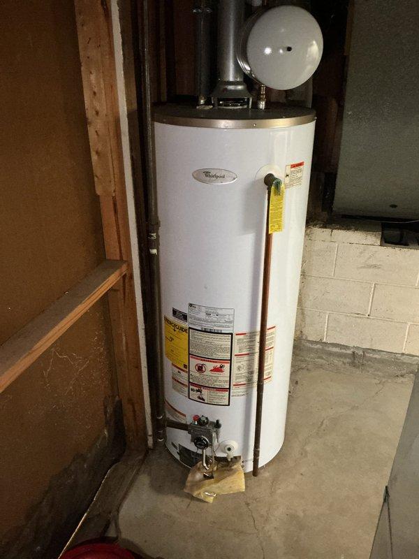 Responded to service call regarding reported issue with tanked water heater system. Upon arrival, performed comprehensive inspection of Whirlpool tank-style water heater unit installed in basement utility area. Evaluated all plumbing connections, including inlet and outlet piping, pressure relief valve, expansion tank mounting, and associated black insulated supply lines. Assessed water heater operation, temperature settings, and proper venting. Verified expansion tank was properly charged and functioning correctly. Inspected all visible copper and PEX connections for leaks or corrosion. Confirmed unit specifications and safety labels were intact and legible. Documented existing installation configuration with photos showing water heater positioning, expansion tank placement, valve locations, and overall plumbing infrastructure layout. System found to be operating within normal parameters upon completion of diagnostic evaluation.