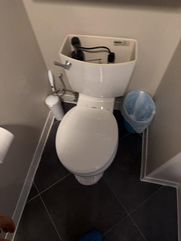 Responded to service call for leaking toilet following unsuccessful self-installation attempts. Upon arrival, inspected toilet installation and identified improper wax ring seal placement as primary cause of leak. Removed toilet from flange, cleaned existing wax residue from both flange and toilet base, and installed new wax ring seal with proper compression and alignment. Reset toilet to flange, ensuring correct positioning and level placement. Torqued closet bolts to manufacturer specifications, connected water supply line, and tested for leaks through multiple flush cycles. Confirmed no active leaks at base or tank connections. Noted evidence of previous water damage visible on ceiling below, indicating leak had been ongoing prior to service intervention. All systems functioning properly upon completion.