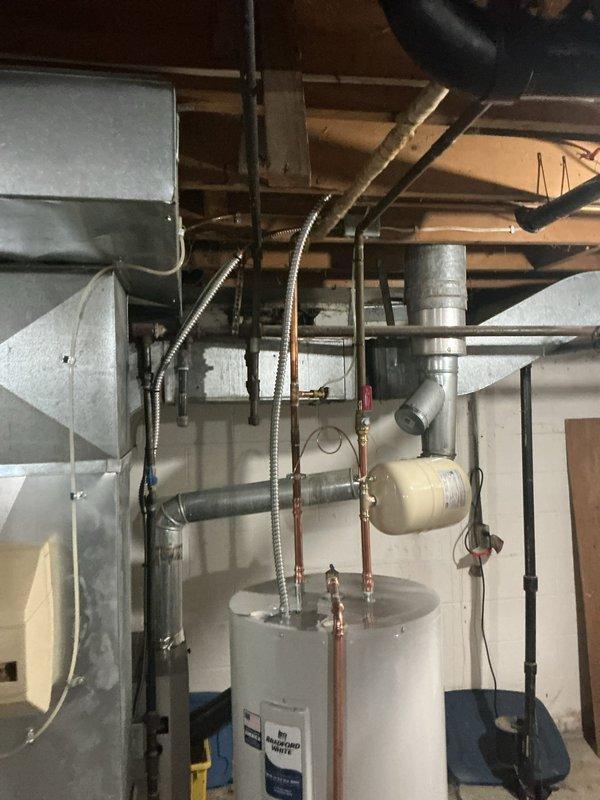 Installed dedicated electrical circuit for electric water heater in basement utility area. Ran new wiring through exposed ceiling joists, terminated connections at water heater location, and verified proper operation of circuit. All work completed per code requirements with appropriate wire sizing for tank specifications.