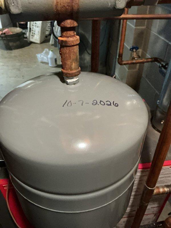 Replaced failed boiler expansion tank due to heavily corroded pipe fitting and compromised system integrity. Removed old tank with rusted connections and installed new cylindrical expansion tank with proper fittings to restore system pressure control and prevent future boiler damage. System tested and confirmed operational upon completion.