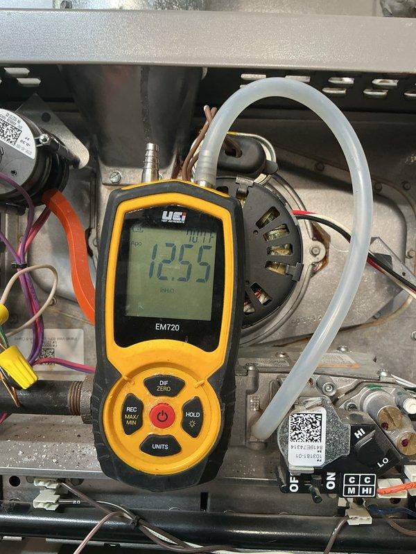 Completed preventive maintenance on a 7-year-old gas furnace under the MVP heating maintenance program. Performed diagnostic measurements using digital manometer, recording gas pressure readings at 12.55" to verify proper combustion and system operation. Inspected blower motor assembly, electrical connections, gas valve terminals, and all associated components, confirming equipment is operating within manufacturer specifications with no deficiencies noted.