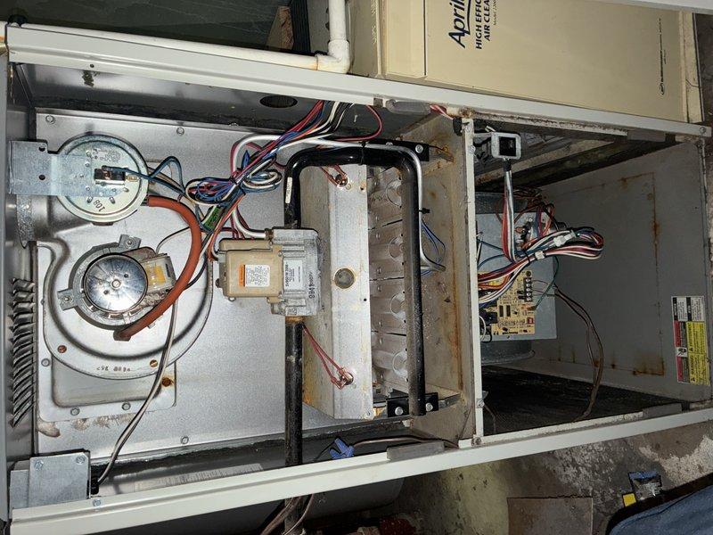 Responded to no-heat call where furnace blower motor failed to activate. Upon inspection, diagnosed blower motor failure and assessed control board connections and gas valve assembly. Documented existing system conditions including aged plumbing infrastructure and internal furnace components showing signs of wear and corrosion for customer review and repair recommendations.