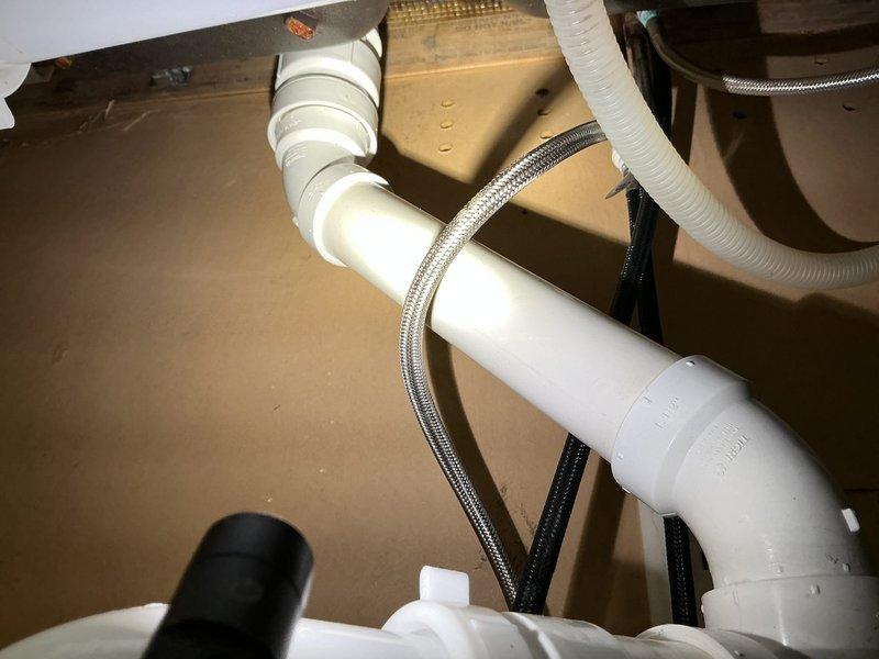Replaced existing sillcock with new frost-free unit on front of house, accessing and installing from crawl space. Replumbed kitchen drain line with new tubular center outlet, tubular trap, and air admittance valve for proper venting. Accessed drain system from crawl space below to complete tie-in connections. Installed customer-supplied kitchen faucet with braided stainless steel supply lines.