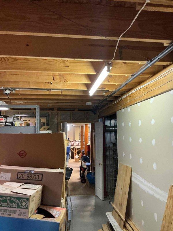 Conducted comprehensive electrical estimate for standby generator installation in unfinished basement area. Assessed existing electrical infrastructure, documented exposed ceiling joists with current ductwork and wiring, evaluated wall conditions and available space for transfer switch and generator connection requirements. Photographed site conditions including structural elements, drywall installation progress, and basement layout to develop accurate scope of work for permanent generator system installation.
