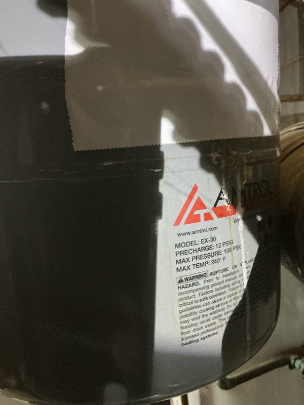 Responded to service call for leaking expansion tank on Weil-McLain CGA-5 hot water boiler installed in 2018. Upon arrival, found Amtrol EX-30 expansion tank with visible penetration in tank surface that had been temporarily patched with tape. Tank was actively leaking and required replacement to prevent system damage and maintain proper pressure regulation. Removed failed expansion tank and installed new Amtrol EX-30 expansion tank with proper pre-charge pressure of 12 PSI. Connected new tank to existing copper piping system, verified all connections for leaks, and confirmed boiler operation. System tested and confirmed functioning properly with no leaks detected.