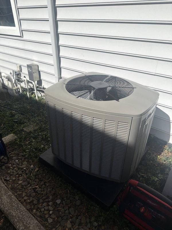 Completed installation of two 90% efficiency furnaces and two air conditioning systems. New outdoor condenser units were positioned on concrete pads with proper clearances from the building structure, electrical disconnects mounted on exterior wall, and refrigerant lines installed. Replaced faulty 25-amp Littelfuse fuses during electrical connections to ensure proper circuit protection for the new equipment. All units tested and operational upon completion.